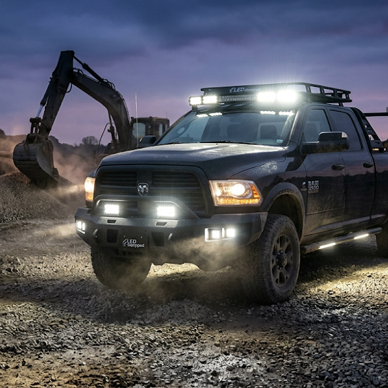 A powerful heavy-duty pickup truck illuminates a rugged